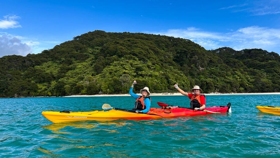 Couple Waving Kayak Abel Tasman National Park