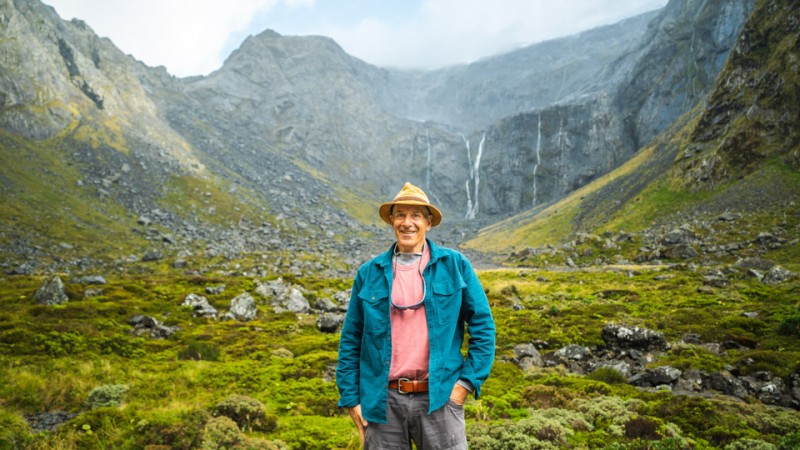 Solo guest with waterfalls in Fiordland National park