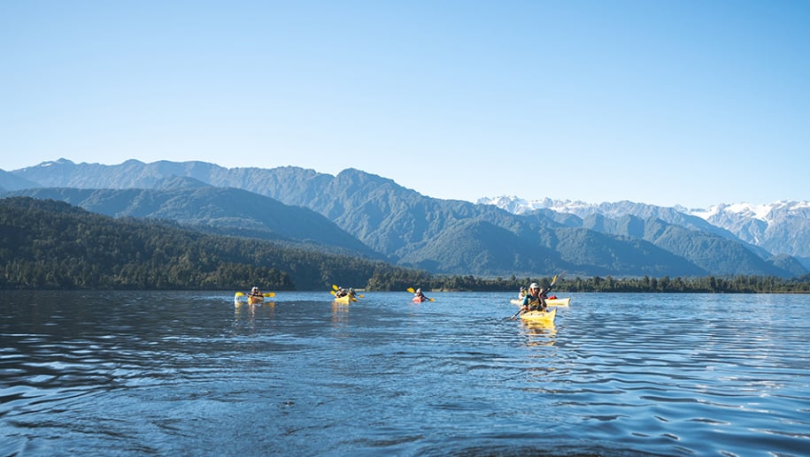 Guests kayaking on Lake Mapourika