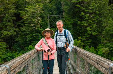Two happy guests on Kepler Track bridge
