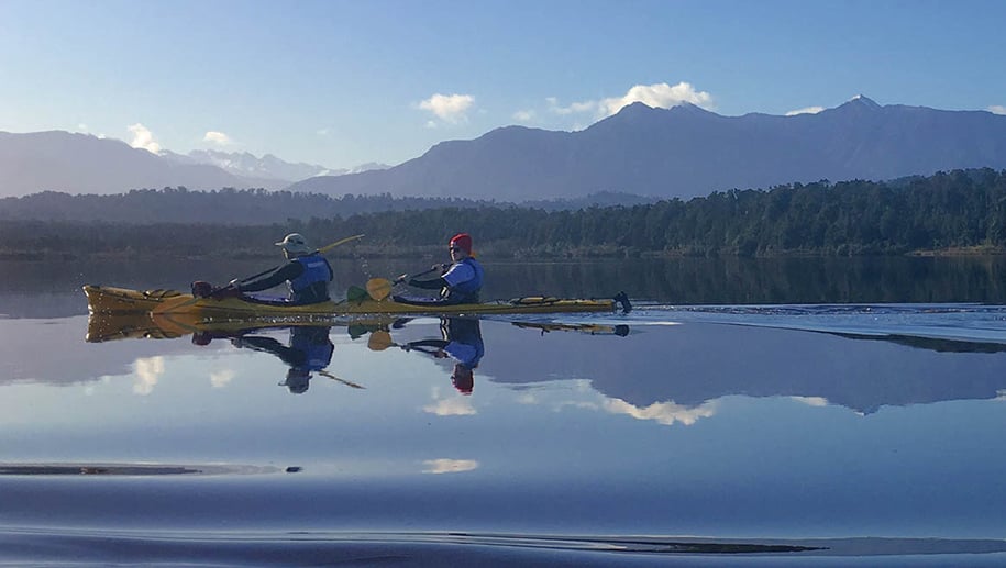 New Zealand walking tours take guests kayaking on the Okarito Lagoon