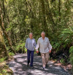 Couple at The Chasm Viewing Bridge, Cleddau river, Fiordland New Zealand
