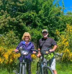 Couple cycling through Arrowtown