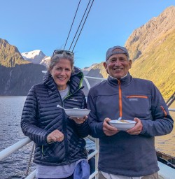 Couple having dinner on the boat at Milford Sound, Fiordland New Zealand