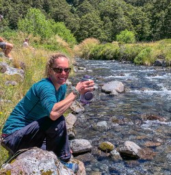 Drinking natural water at Monkey Creek, Fiordland New Zealand
