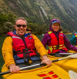 Family kayaking at Milford Sound, Fiordland New Zealand