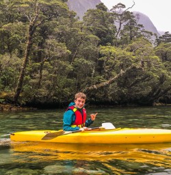 Young kayaker at Milford Sound, Fiordland New Zealand