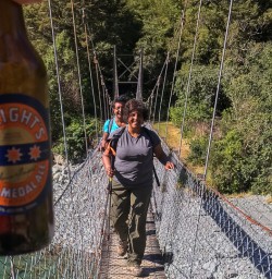 Guests on the bridge at Hollyford track, Fiordland New Zealand