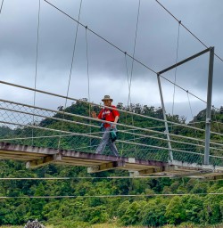 Guests crossing swing bridge Paparoa National Park