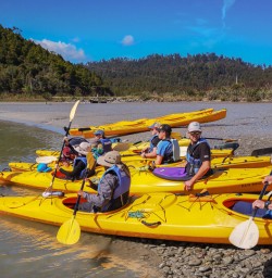 Group ready to kayak at Okarito Lagoon, West Coast New Zealand