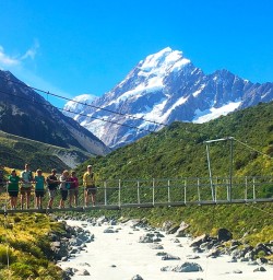 Aoraki/Mt Cook towers over our intrepid heritage walkers. Hooker Valley walk.