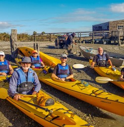 Group ready to kayak at Okarito Lagoon, West Coast New Zealand
