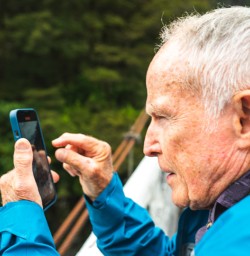 13 Dennis Widman taking pics at Milford Sound