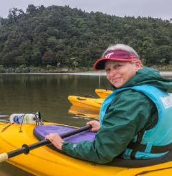 Guest ready to kayak at Okarito Lagoon, West Coast New Zealand