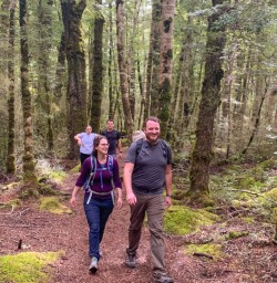 1. Happy guests walking through beech forest