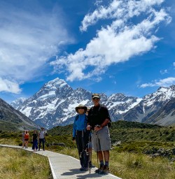 Couple hiking Hooker Valley board walk