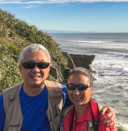 Couple at  Punakaiki Pancake Rocks and Blowholes, Porarari National Park West Coast New Zealand