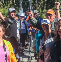 Group on the bridge at routeburn track river, Otago New Zealand