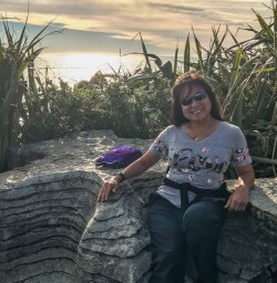 Lady at  Punakaiki Pancake Rocks and Blowholes, Porarari National Park West Coast New Zealand