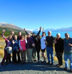 Our team posing for a group shot at Lake Pukaki with Aoraki Mount Cook in the background