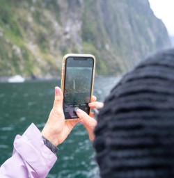 2. Guest taking pictures on Milford Cruise