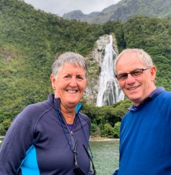 3 Smiling guests at Bowen Falls Milford Sound Cruise