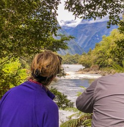 Couple at Arthur river, Fiordland New Zealand