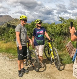 Couple biking the Queenstown trail, Otago New Zealand