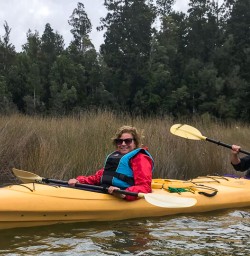 Couple kayaking at Okarito Lagoon, West Coast New Zealand