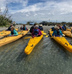 Group ready to kayak at Okarito Lagoon, West Coast New Zealand