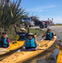 Group ready to kayak at Okarito Lagoon, West Coast New Zealand