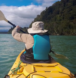 Guest kayaking at Okarito Lagoon, West Coast New Zealand