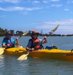 Happy couple kayaking at Okarito Lagoon, West Coast New Zealand