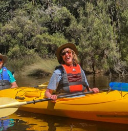 Happy couple kayaking at Okarito Lagoon, West Coast New Zealand