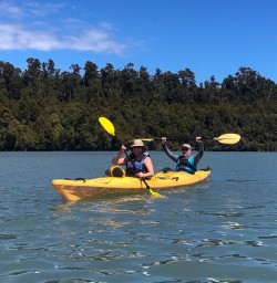 Happy guests kayaking at Okarito Lagoon, West Coast New Zealand
