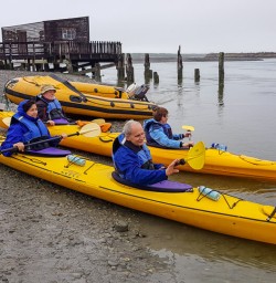 Group ready to kayak at Okarito Lagoon, West Coast New Zealand