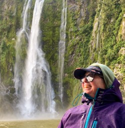 3. Happy guest next to waterfall Milford Sound