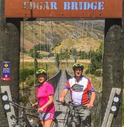 Couple biking the Edgar Bridge, Queenstown Trail Otago New Zealand