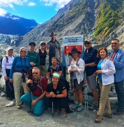 The team stops for a group shot at Fox Glacier