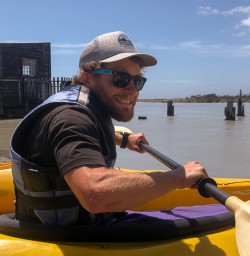 Guide ready to kayak at Okarito Lagoon, West Coast New Zealand