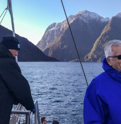 Happy guest on the boat at Milford Sound, Fiordland Southland New Zealand