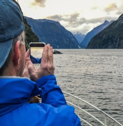 Taking picture from boat at Milford Sound, Fiordland National Park Southland New Zealand