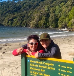 4. Two guests next to Maori Beach sign