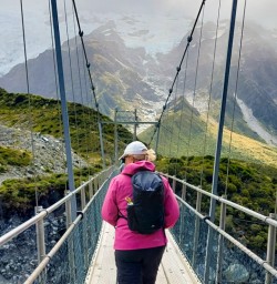 4. Guests crossing bridge on Hooker Valley Track