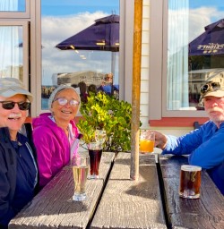 4. Guests enjoying a beer on Stewart Island