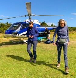 4. Two guests getting out helicopter Martins Bay