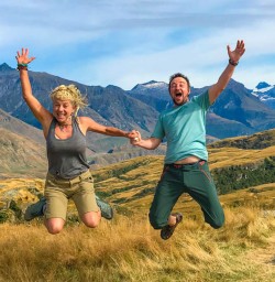Couple jumping up Rocky Mountain summit