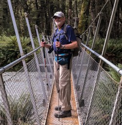 Guest on the bridge at Routeburn track river, Otago New Zealand