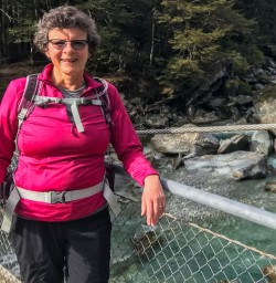 Guest on the bridge at Routeburn track river, Otago New Zealand
