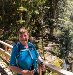 Guest on the bridge at Routeburn track river, Otago New Zealand